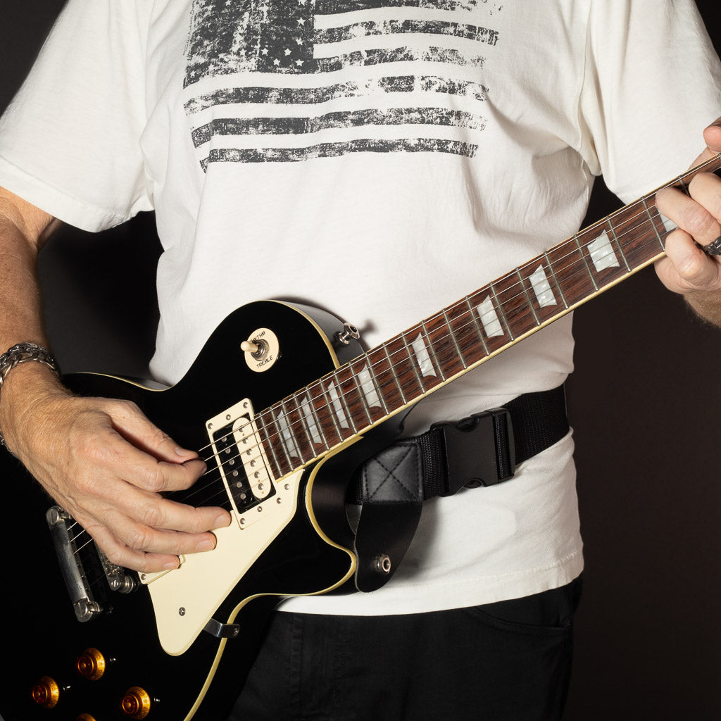 waist guitar strap from Slinger Straps supporting a black Gibson Les Paul guitar