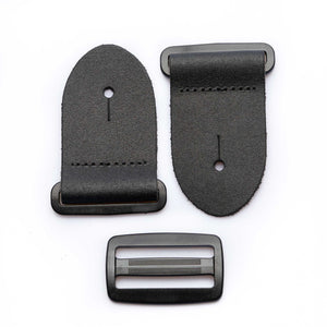 frontside of a 2-inch black leather guitar strap end kit with acetal plastic hardware
