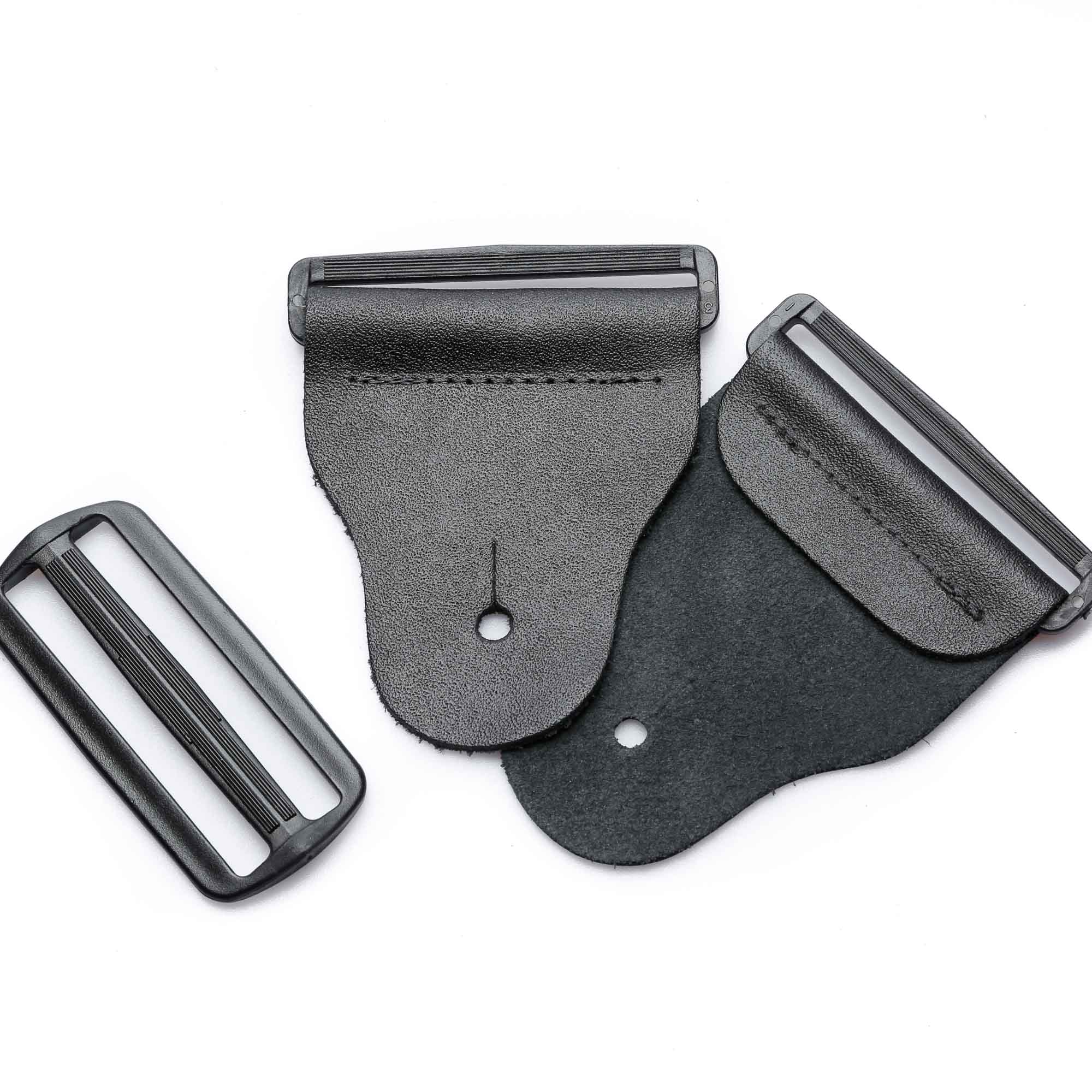 frontside of a 3-inch tapered black leather guitar strap end kit with acetal plastic hardware