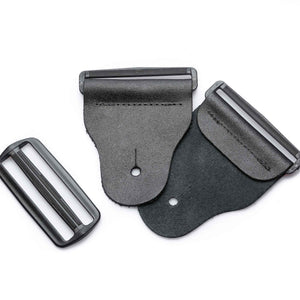 mixed view of a 3-inch tapered black leather guitar strap end kit with acetal plastic hardware
