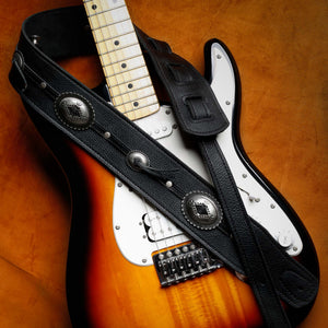 black leather with silver conchos guitar strap on a Fender Stratocaster
