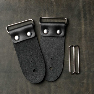 backside of black leather guitar strap end kit for a guitar strap with nickel hardware