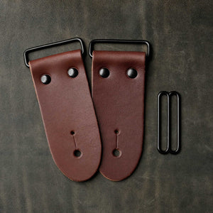 frontside of brown leather strap end kit for a guitar strap with black hardware