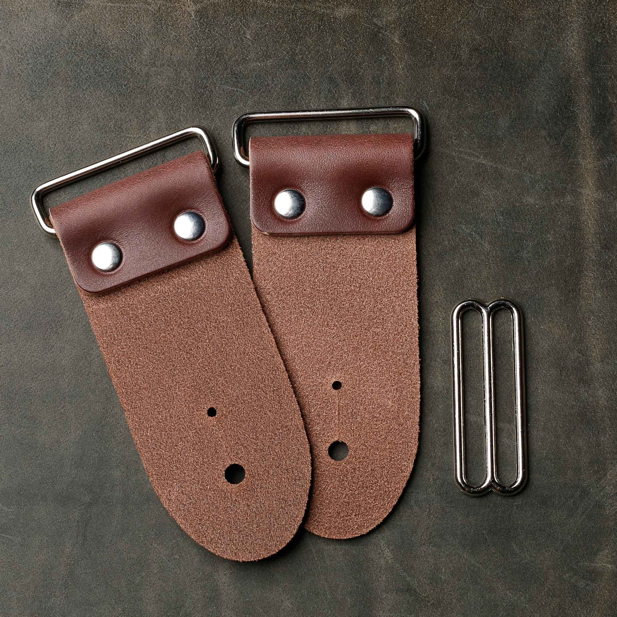 backside of brown leather strap end kit for a guitar strap with nickel hardware