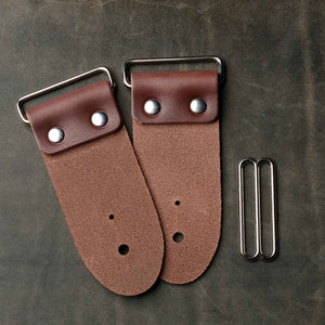 backside of brown leather strap end kit for a guitar strap with nickel hardware