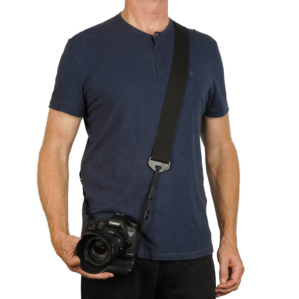 Canon camera on a man with a camera strap made of 2&quot; wide heavy-duty elastic material over shoulder