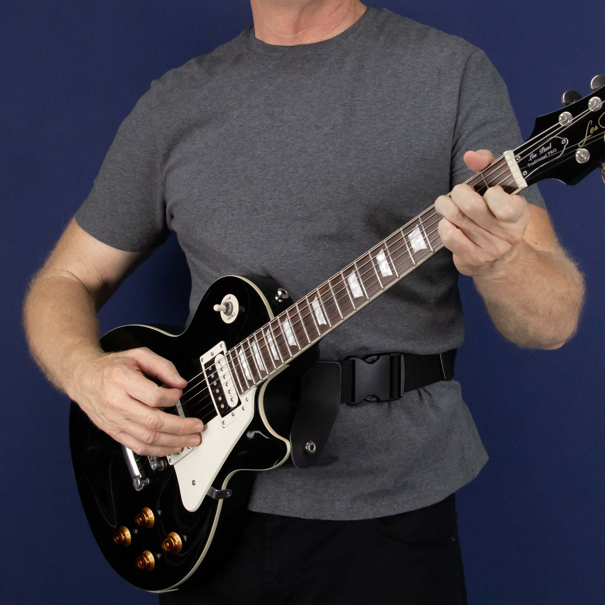 front view of Gibson Les Paul electric guitar worn with a waist guitar strap