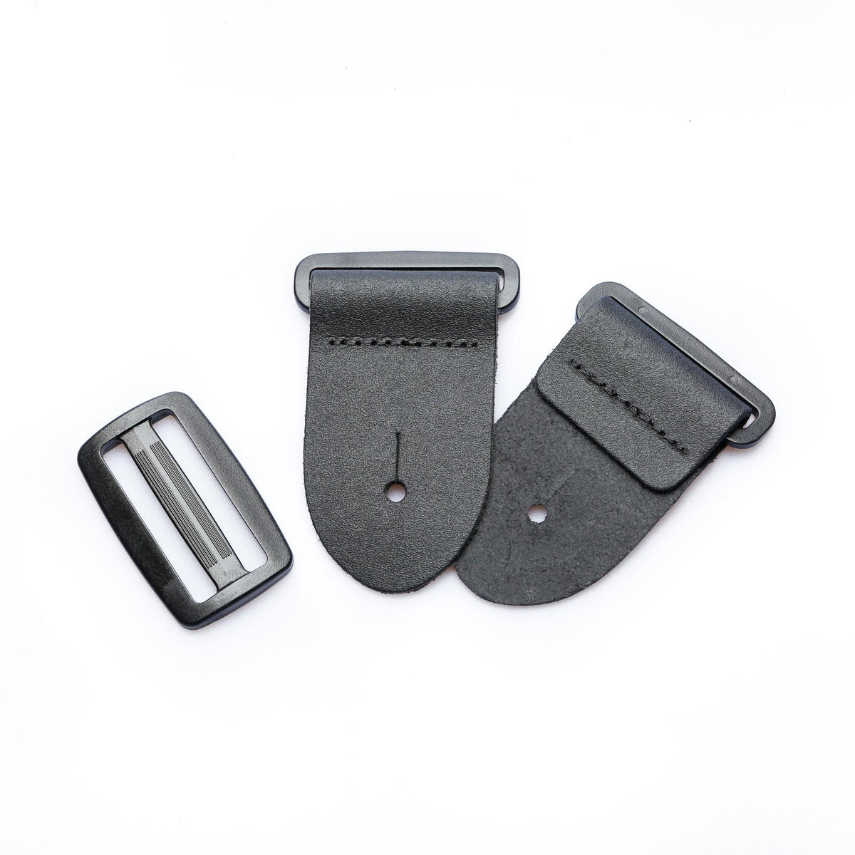 mixed view of a 2-inch black leather guitar strap end kit with acetal plastic hardware