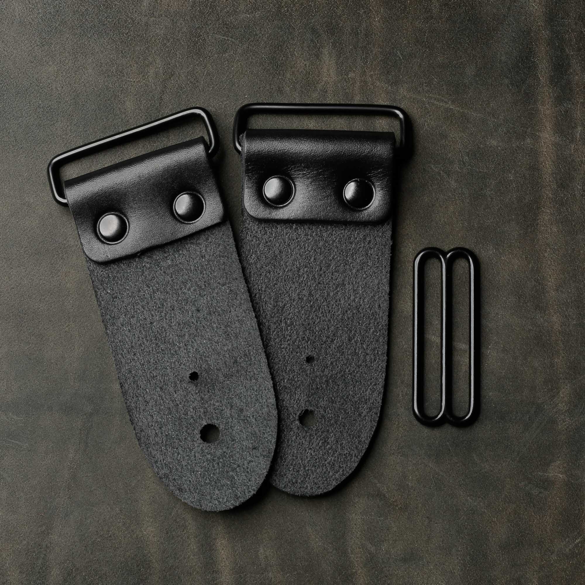 backside of black leather guitar strap end kit for a guitar strap with black hardware