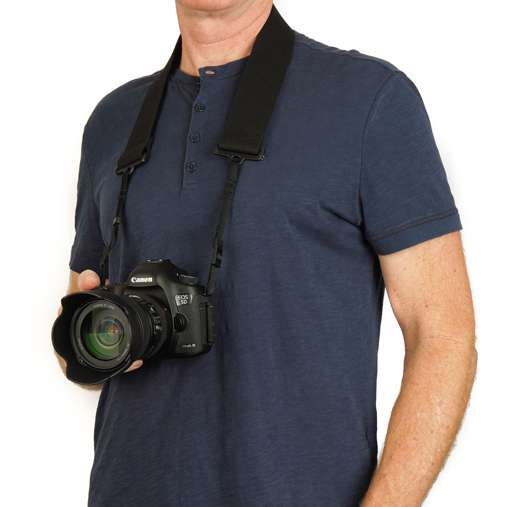 Camera strap made of 2" wide heavy-duty elastic material attached to a Canon camera