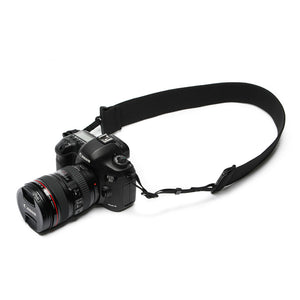 Camera strap made of 2" wide heavy-duty elastic attached to a Canon camera
